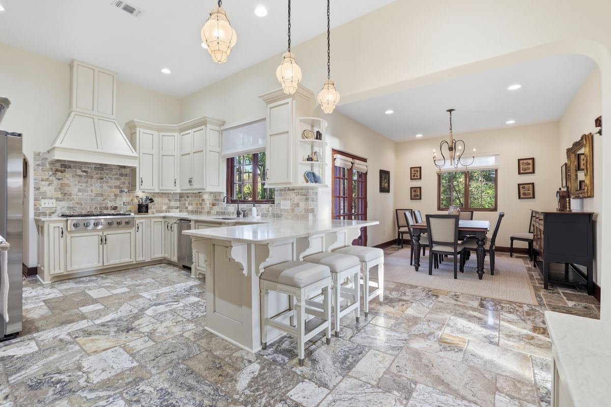 Estate kitchen · Travertine + copper